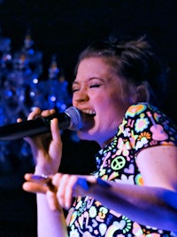 a woman singing into a microphone