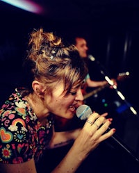 a woman singing into a microphone