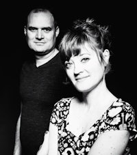 a man and woman posing for a black and white photo